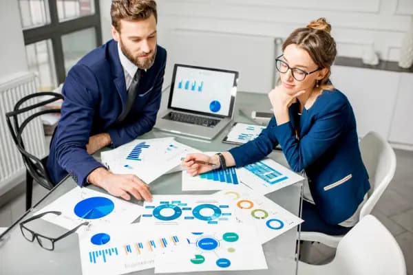 two people looking at graphs