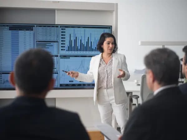 person giving a presentation with a white board